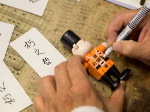 Mayor Ko leaves his signature on a nutcracker bear.